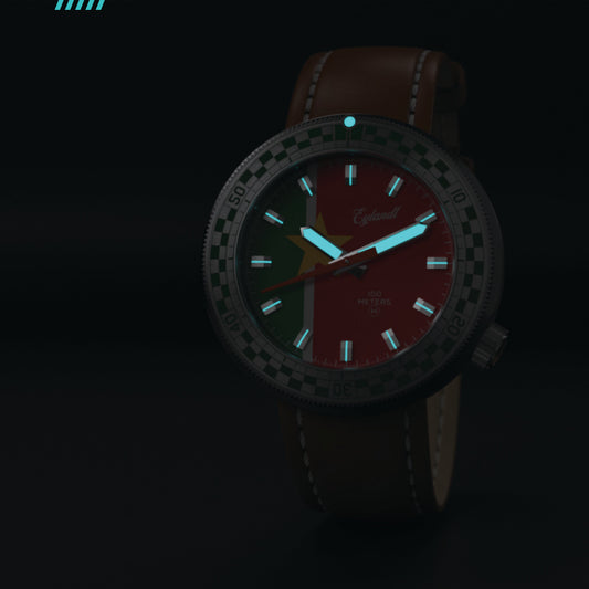 Snelway SRNM diver watch with a red and green luminous dial, a black stainless steel case, and a brown leather strap.