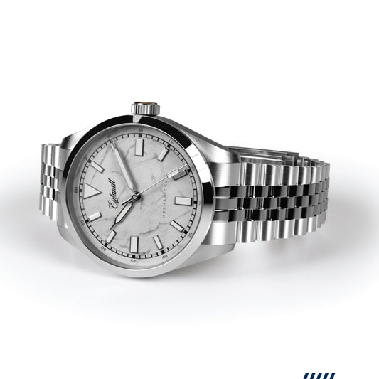 The Aurelian mechanical watch with a white marble dial, brushed stainless steel case, polished bezel, and a stainless steel jubilee