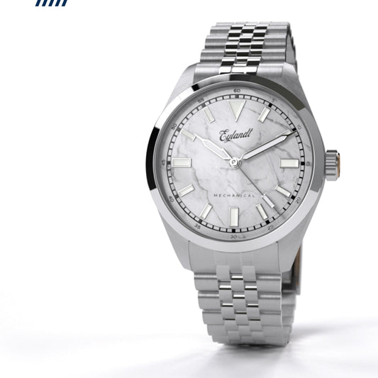 Eylandt The Aurelian mechanical watch with white marble dial, brushed stainless steel case, polished bezel, and stainless steel jubilee