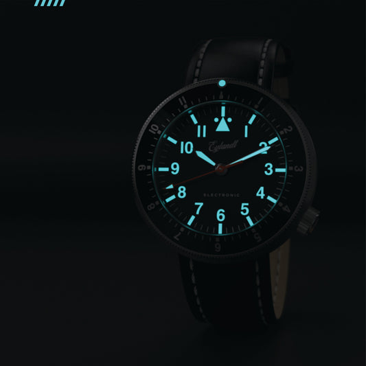 Eylandt The Navigator pilot watch with a black luminous dial, black PVD case, and black leather strap.