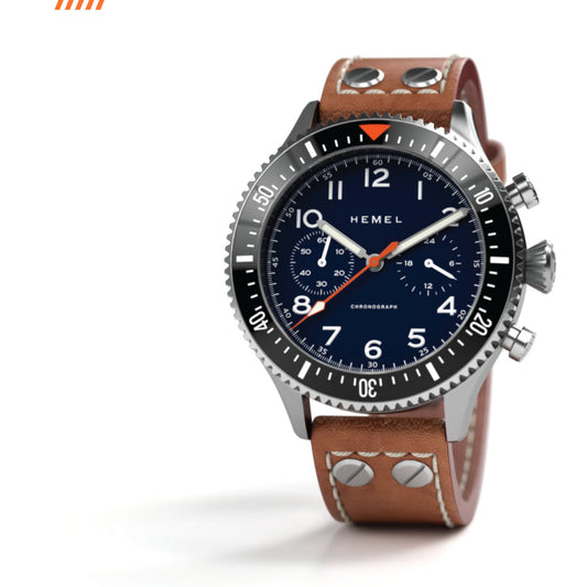 Hemel HFT20 chronograph with a navy blue dial, brushed stainless steel case, black rotating bezel, and brown leather strap.